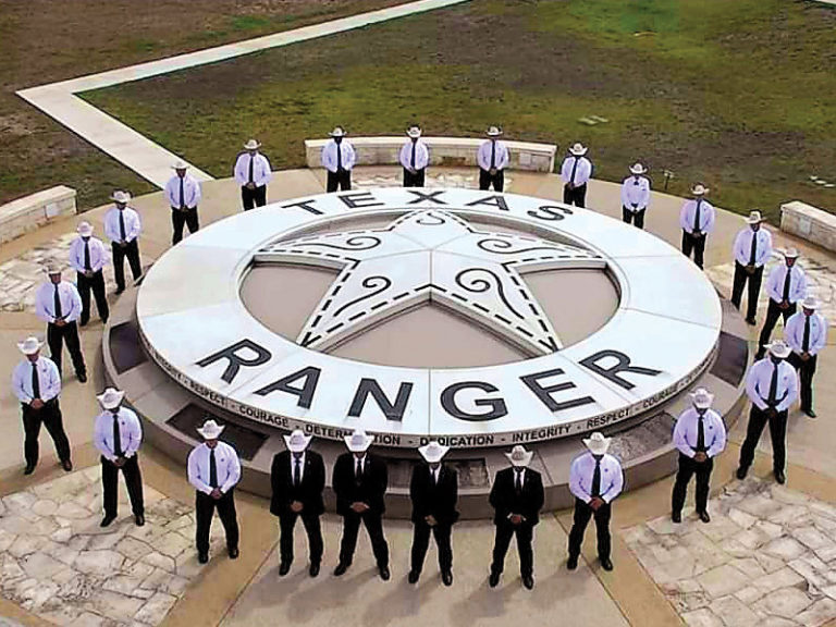 Texas Rangers standing around Texas Ranger Monument