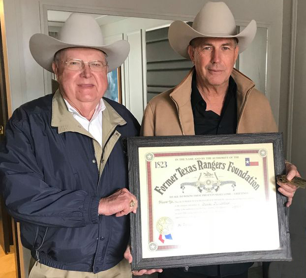 President Ranger Davis giving membership certificate to Kevin Cosner